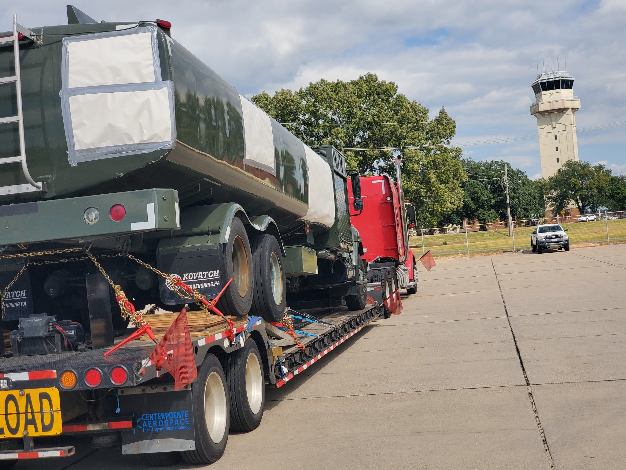 Heavy equipment secured with chains on a lowboy trailer