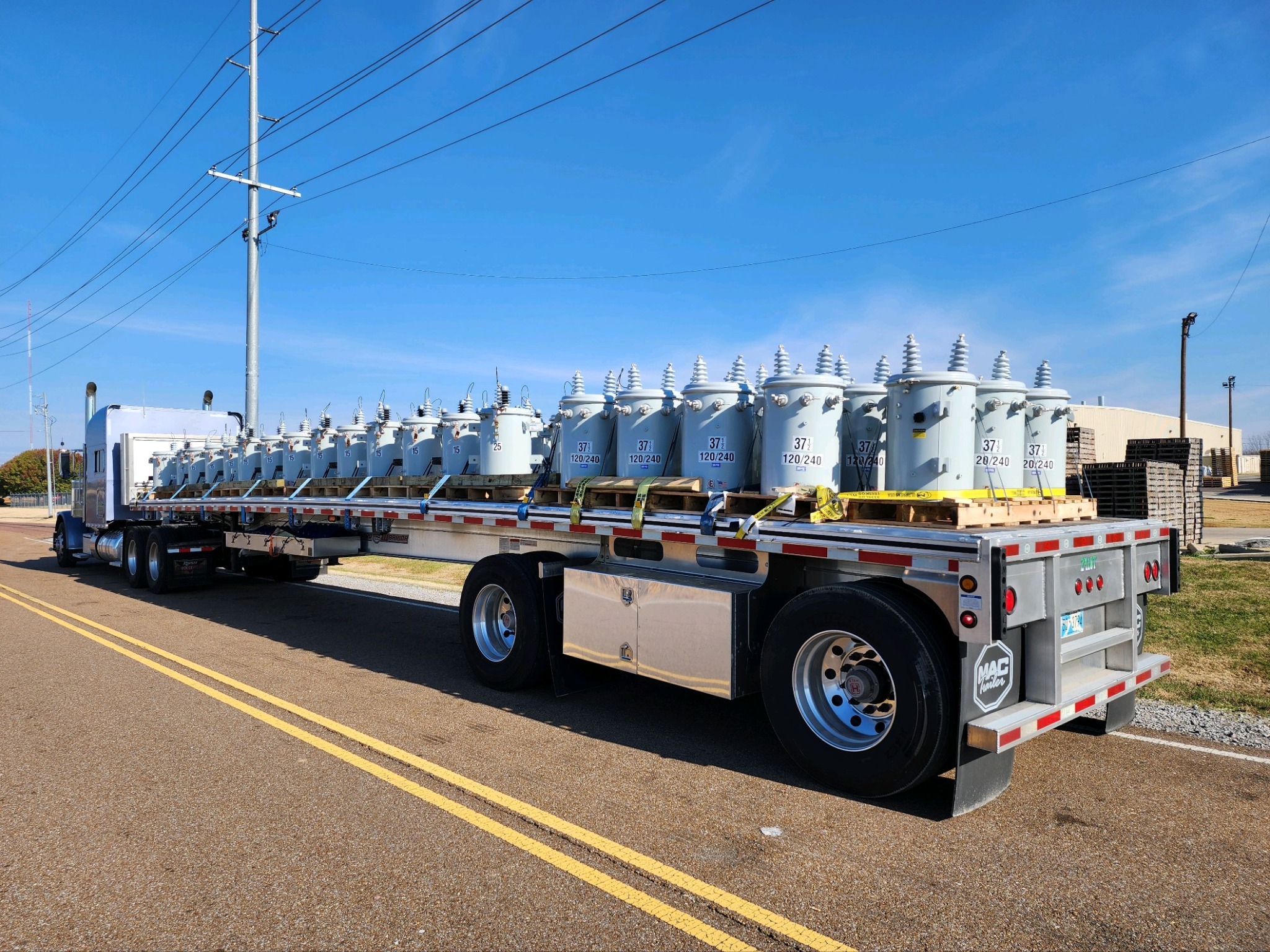 Electrical transformers secured on a flatbed trailer